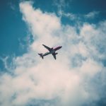 low-angle-view-of-airplane-in-clouds